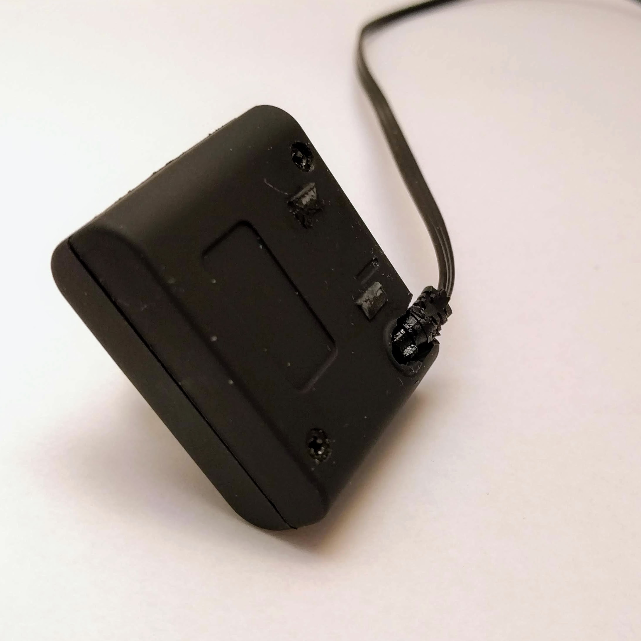 We have to put a small hole into the camera case in order to move the cable from the back to the top. The clip is also being removed.